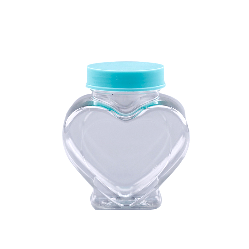 Tarros de comida de botella de plástico en forma de corazón de venta caliente de 50 ml los envases de dulces con tapón de rosca azul FD-009